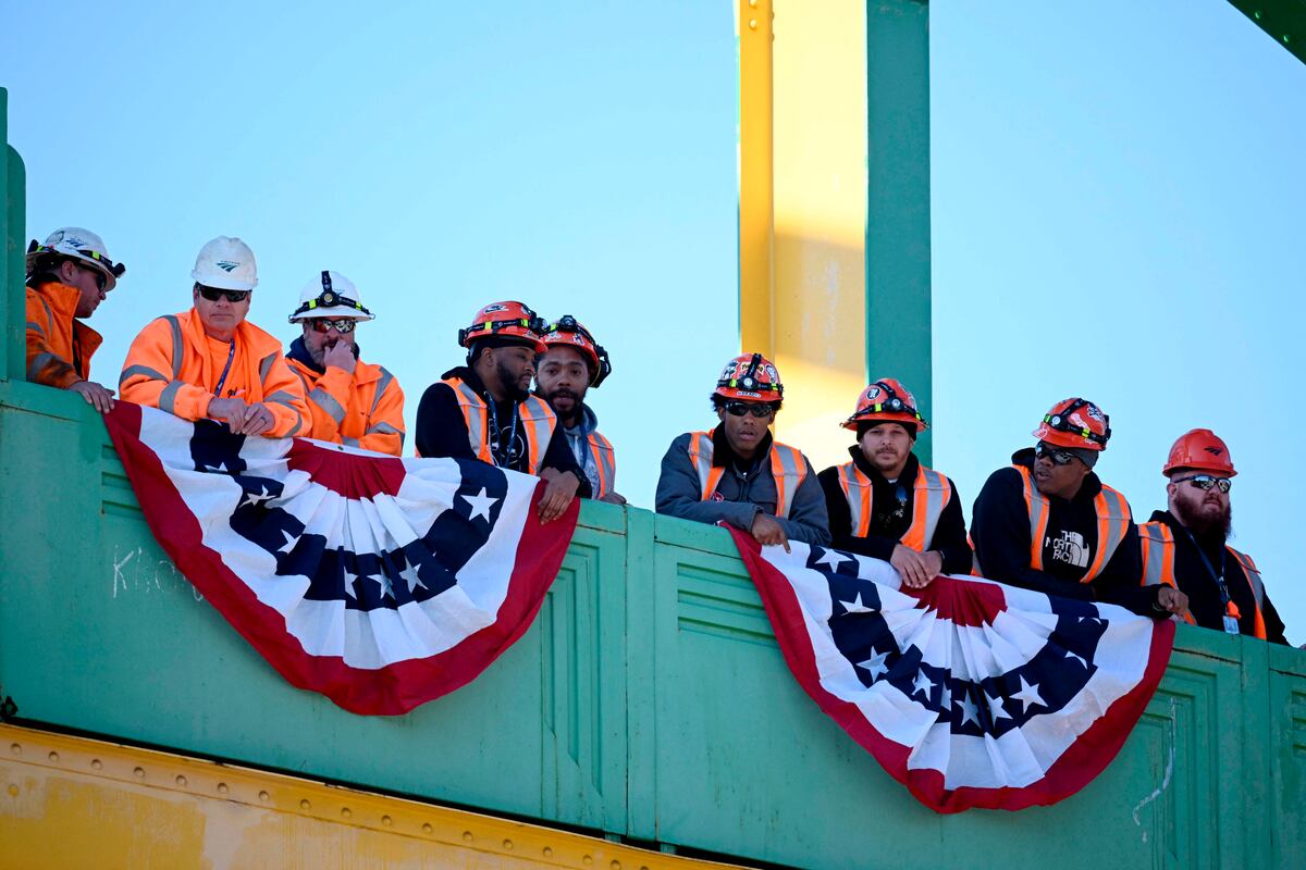 Workers watch as US President Joe Biden, not pictured, delivers remarks on the Bipartisan Infratructure Law at the Baltimore and Potomac Tunnel North Portal in Baltimore, Maryland, on January 30, 2023.